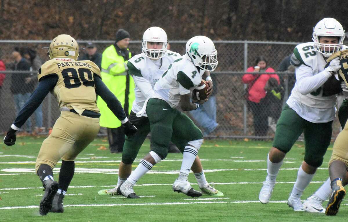 Maloney’s Elliott Good hands the ball off to James Tarver in the Class L semifinals game between Maloney and Platt at Falcon Field, Meriden on Sunday, December 2, 2018. (Pete Paguaga, Hearst Connecticut Media)