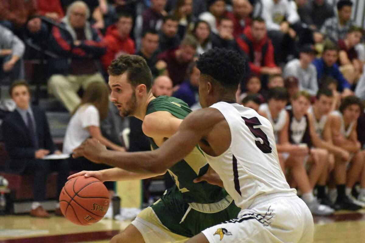 Notre Dame-West Haven’s Connor Raines drives against East Lyme’s Dev Ostrowski at East Lyme on Saturday, December 15, 2018. (Pete Paguaga, Hearst Connecticut Media)