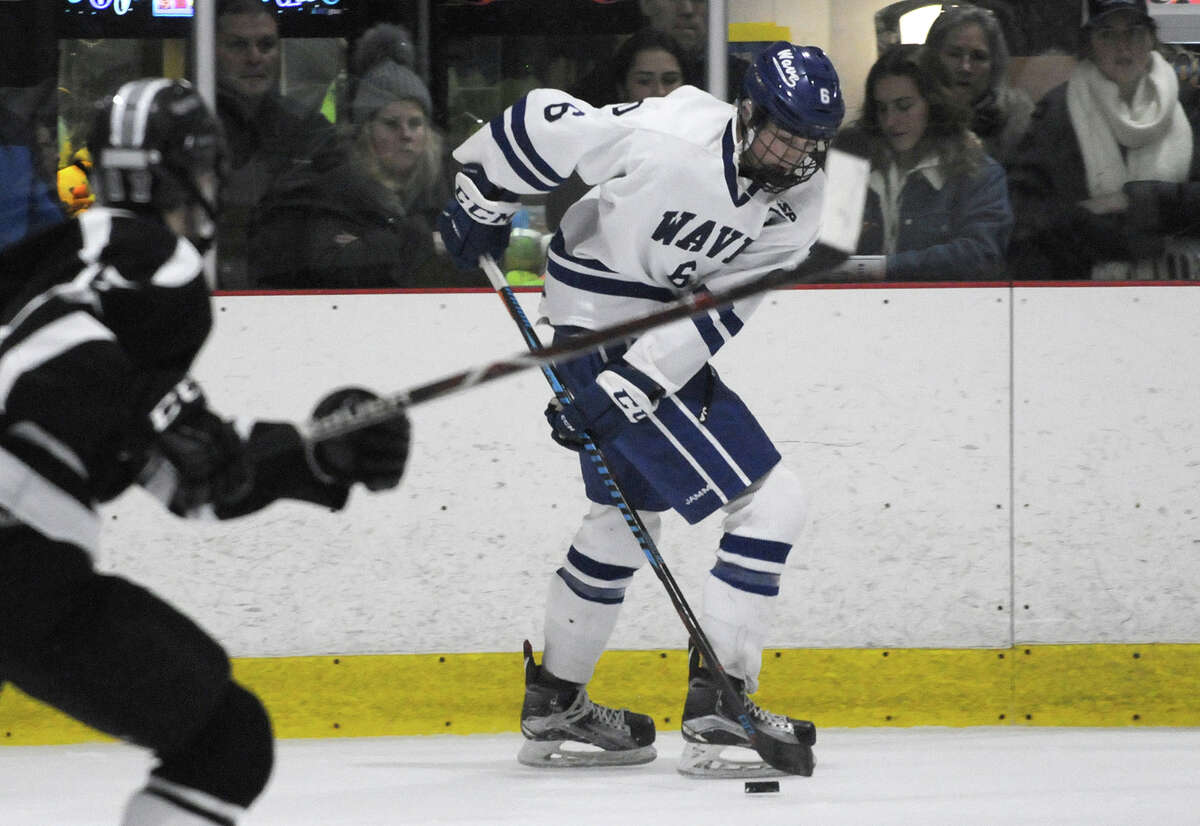 Darien senior co-captain James Gregory (6) controls the puck along the boards during a boys ice hockey game between the Blue Wave and Xavier on Saturday, Jan. 5, at the Darien Ice House. — Dave Stewart/Hearst Connecticut Media photo