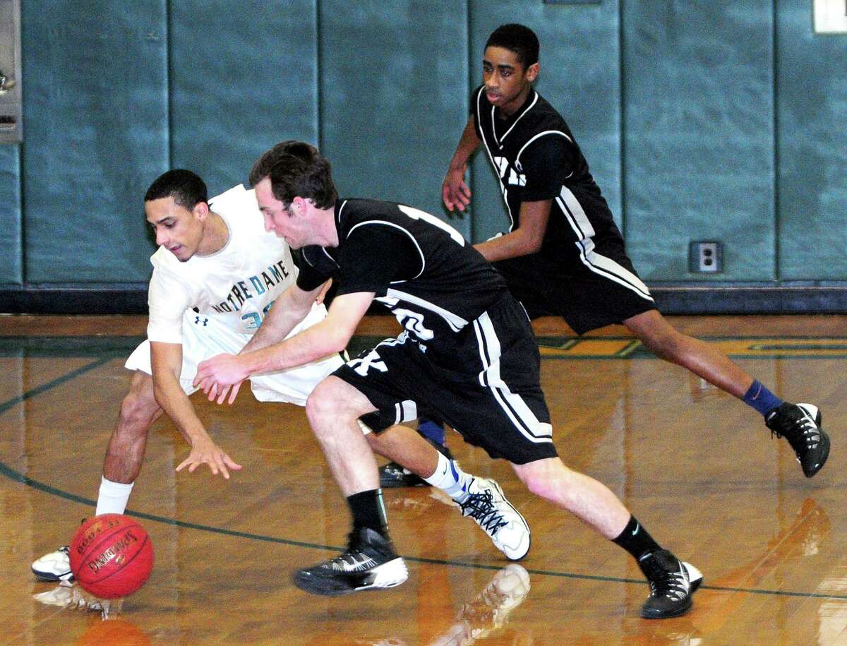 (Arnold Gold — New Haven Register) Joe McCormack (center) of Xavier tries to steal the ball from Lonnie Blackwell (left) of Notre Dame on 2/7/2014.