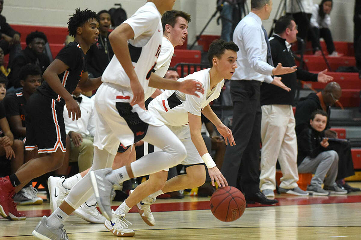 New Canaan’s Ben Sarda and the Rams break out during a win over Stamford a NCHS on January 10. — Dave Stewart/Hearst Connecticut Media photo