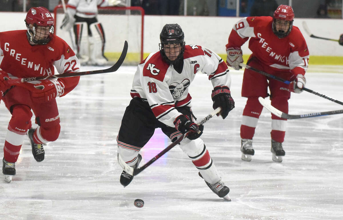 New Canaan's Gunnar Granito skates up the ice during a boys ice hockey game at the Darien Ice House on Monday, Feb. 4.