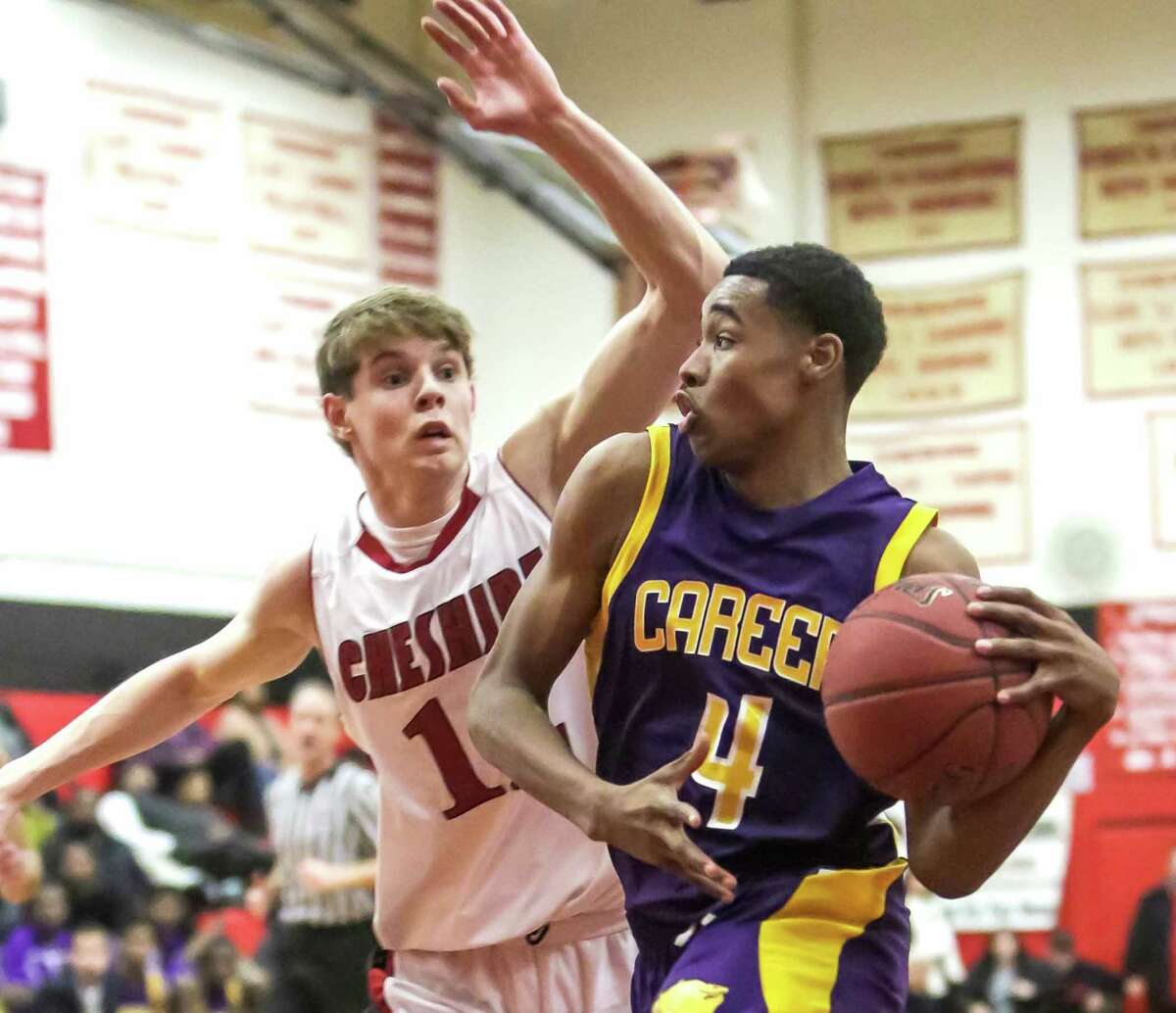Career guard Tyreek Perkins dribbles thru the lane against Cheshire’s Reid Duglenski in a game played last month. Career has already clinched the SCC Oronoque Division title while Cheshire has clinched a tie in the SCC Housatonic Division.