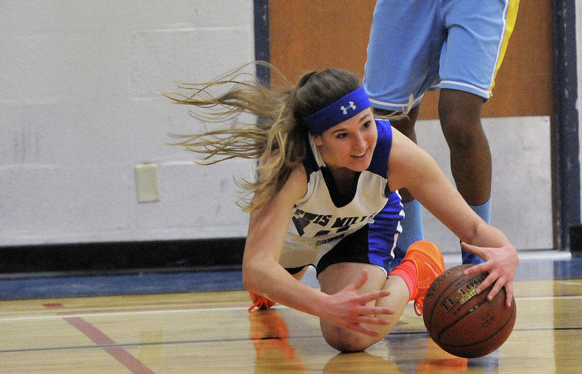 Lewis Mills’ Lesleigh Carter drives for a loose ball in the Spartans 63-34 loss to Kolbe Cathedral.