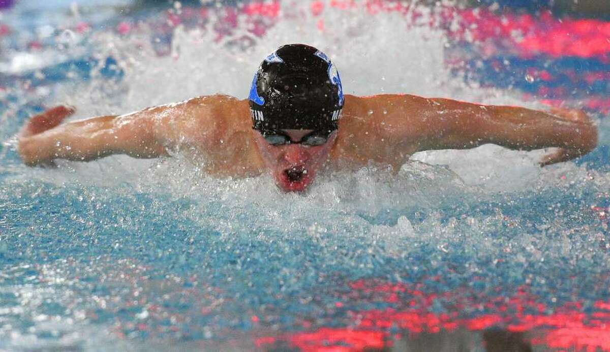 Darien’s Connor Martin competes in his second-place run in the 100 meter butterfly in Greenwich’s 109-76 win over Darien in the high school boys swim meet at the Darien YMCA in Darien, Conn. Monday, Dec. 17, (Tyler Sizemore)