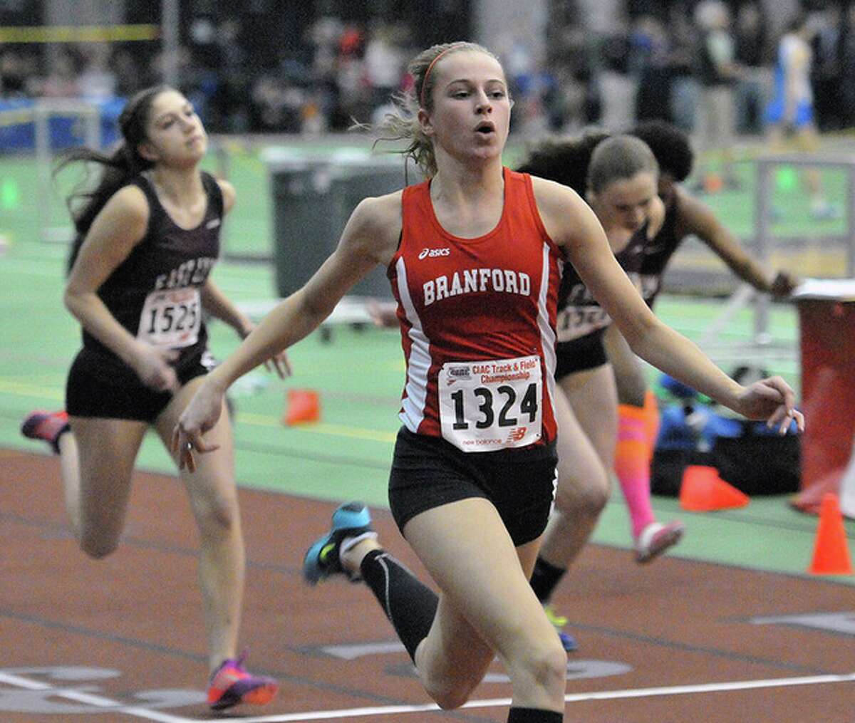 Branford’s Anna Atkinson crosses the finish to win the 55 hurdles final at the Class L State Track Championships.