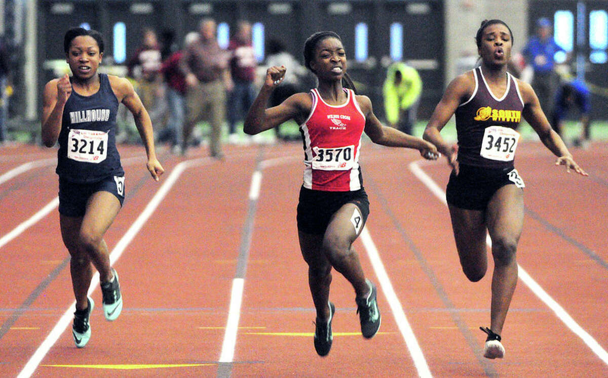 Chaslynn Saucier (center) of Wilbur Cross finishes first in the 55m dash finals at the State Open in New Haven on 2/17/2014. Photo by Arnold Gold/New Haven Re