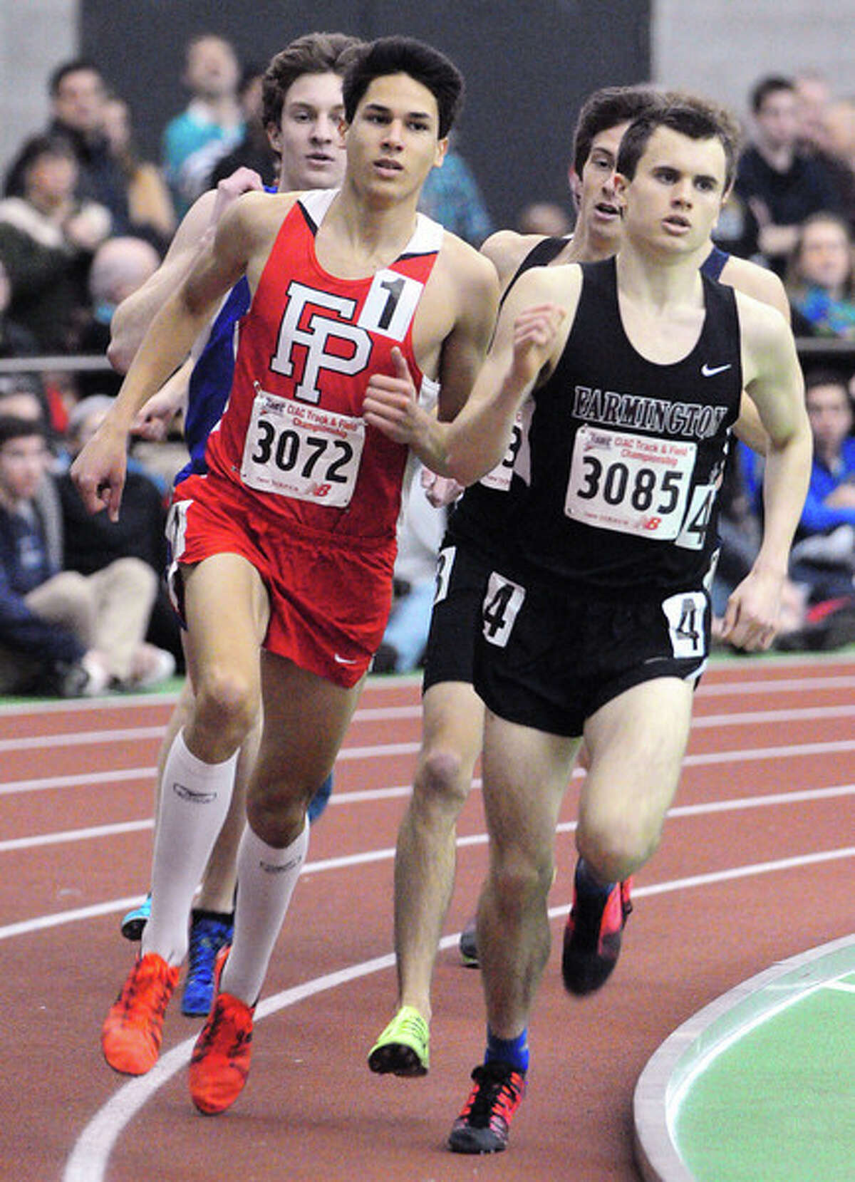 Chris Alvarado (left) of Fairfield Prep and Matt Chisholm (right) of Farmington are lead the pack in the 1600 meter run at the State Open in New Haven on 2/17/2014. Photo by Arnold Gold/New Haven Register