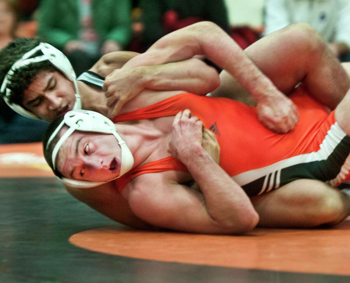 Shelton’s LiamCummings is down but not out he went on to win the SCC Championship match agsinst Seve Burgos of Xavier 2/15. (Melanie Stengel — New Haven Register)