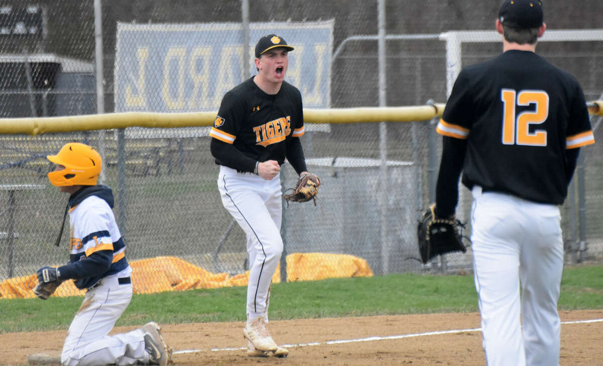 Hand’s Phoenix Billings celebrates after tagging out a runner at third base at Ledyard High School on Thursday, April 18, 2019. (Pete Paguaga, Hearst Connecticut Media)