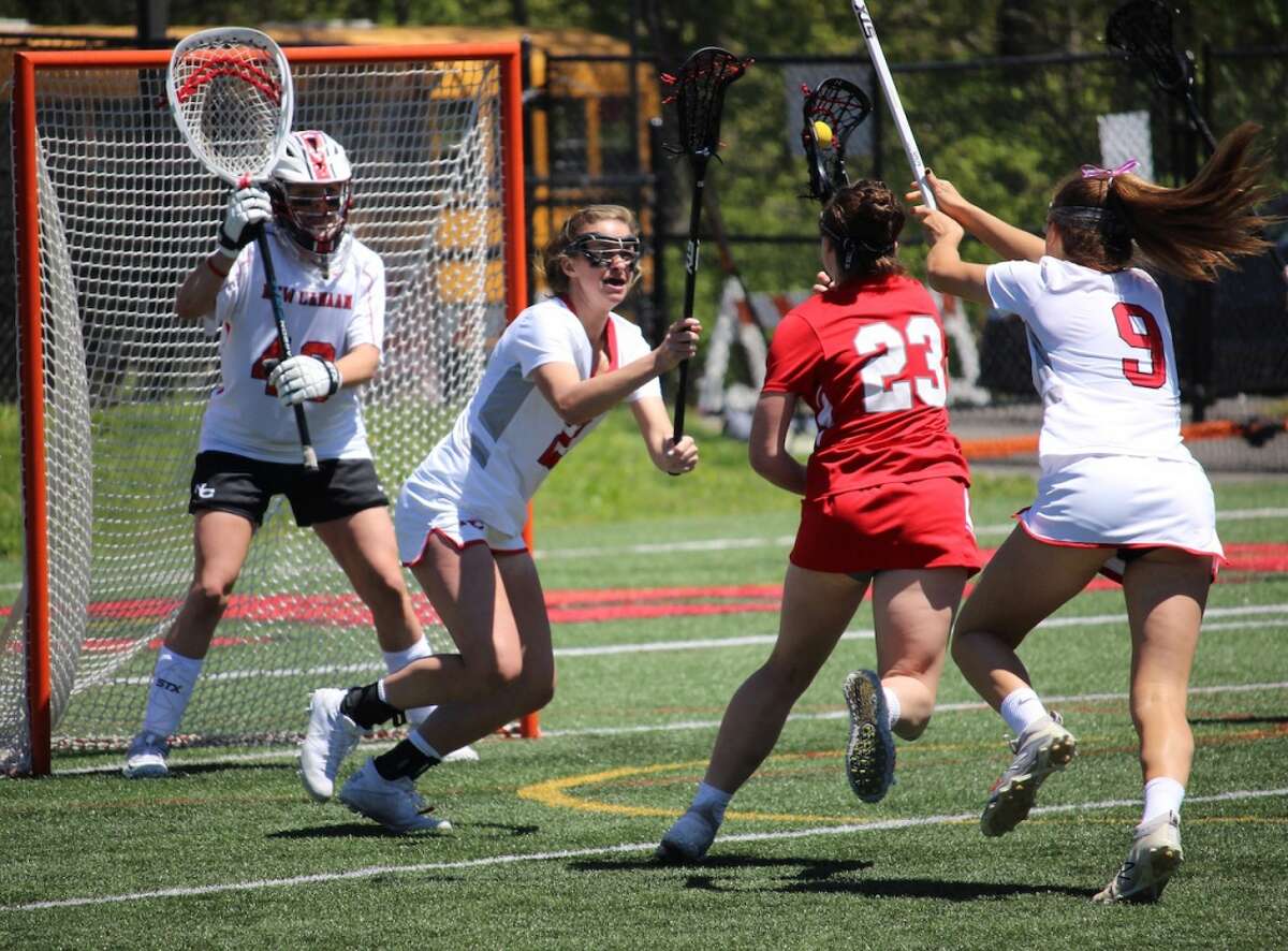 New Canaan’s Caroline Schuh (20) and Katelyn Sparks (9) defends against a shot by Greenwich’s Jess Ware (23) during a girls lacrosse game at Dunning Field in New Canaan on Saturday, May 11, 2019. — Terry Dinan/Hearst Connecticut Media