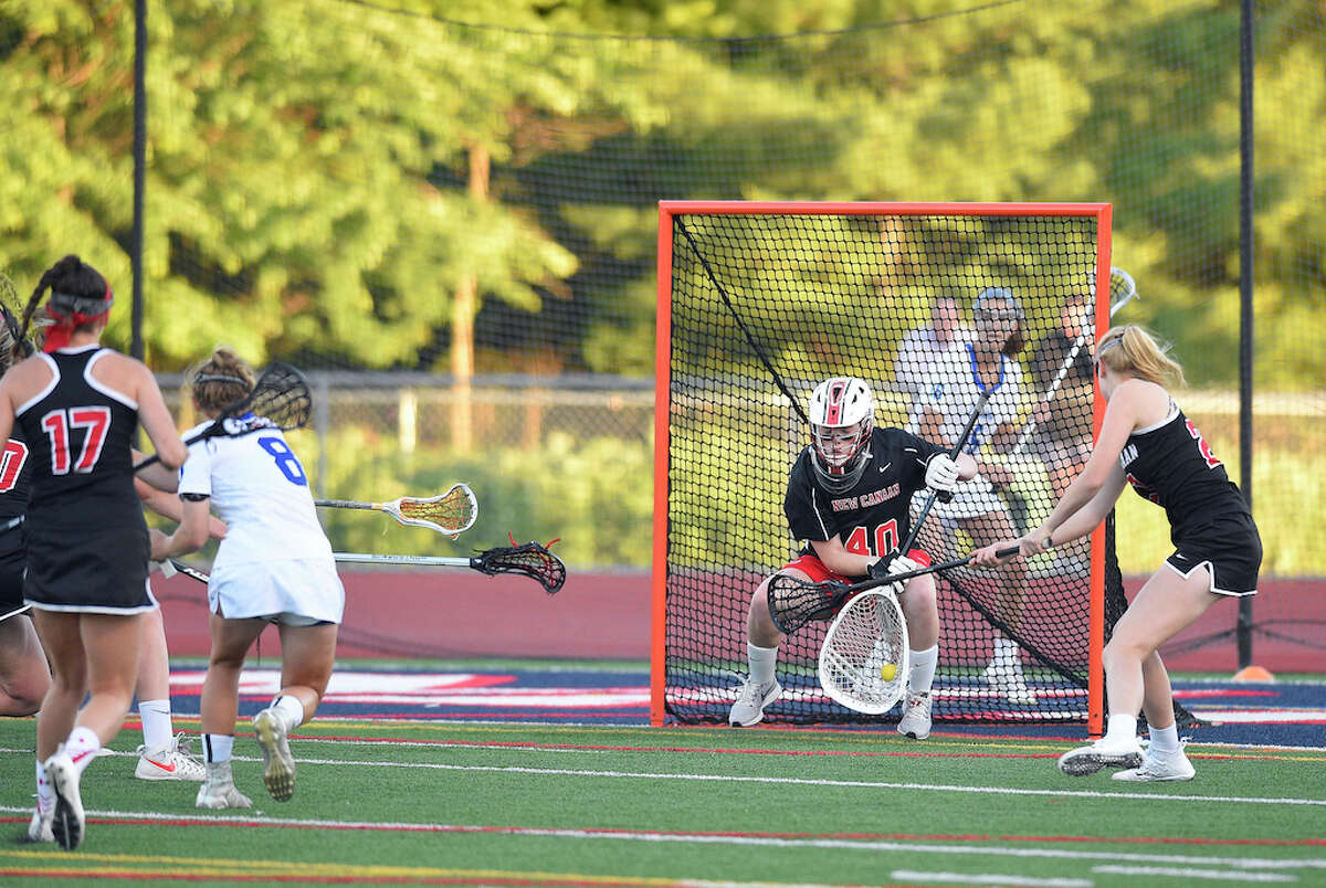 New Canaan goalie Caroline O’Dea makes a stop on Darien Emma Jaques (8) in the first half of a CIAC Class L semifinal girls lacrosse game at Jack Casagrande Field on June 5, 2018 in Norwalk, Connecticut.