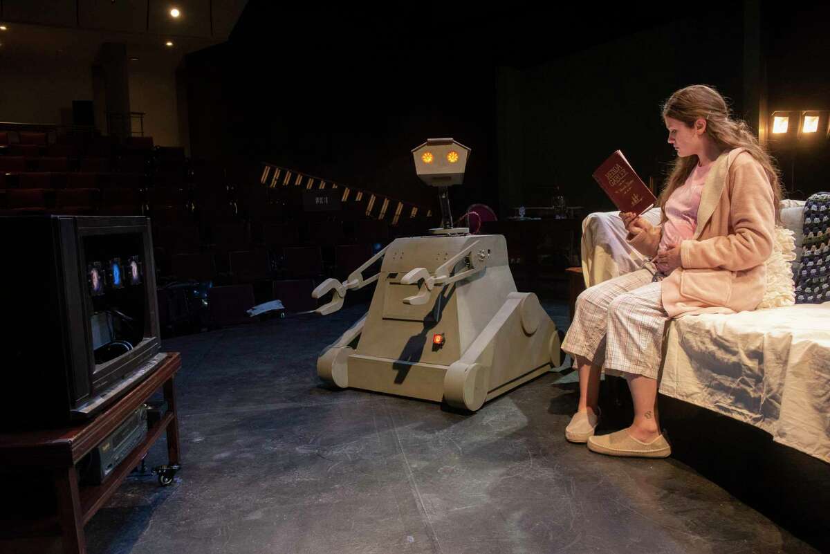 A robot named Billy Bot is seen on stage with Sophie Pettit who plays the part of Jane as students rehearse for the production of "Heddatron," about a woman kidnapped by robots and forced to perform the play "Hedda Gabler" in the Janet Kinghorn Bernhard Theater at Skidmore College on Tuesday, April 19, 2022 in Saratoga Springs, N.Y. The robots were built by Ballston Spa high school students.