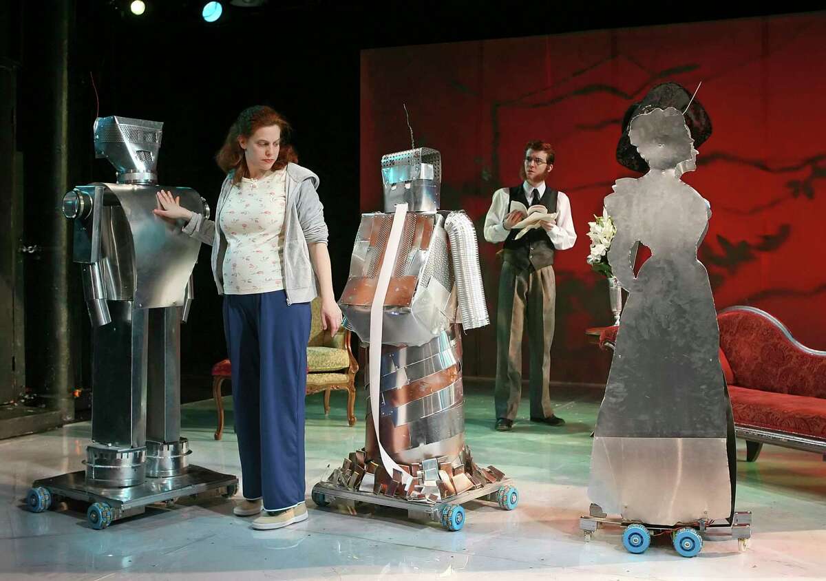 FILE -- Carolyn Baeumler, left, and Daniel Larlham, with robot cast mates in the production of "Heddatron," in New York, Feb. 18, 2006. Humans are sharing the stage with robot colleagues in more and more stage productions, and both kinds of actors are benefiting from the collaboration. (Sara Krulwich/The New York Times) -- PHOTO MOVED IN ADVANCE AND NOT FOR USE - ONLINE OR IN PRINT - BEFORE JULY 08, 2012.
