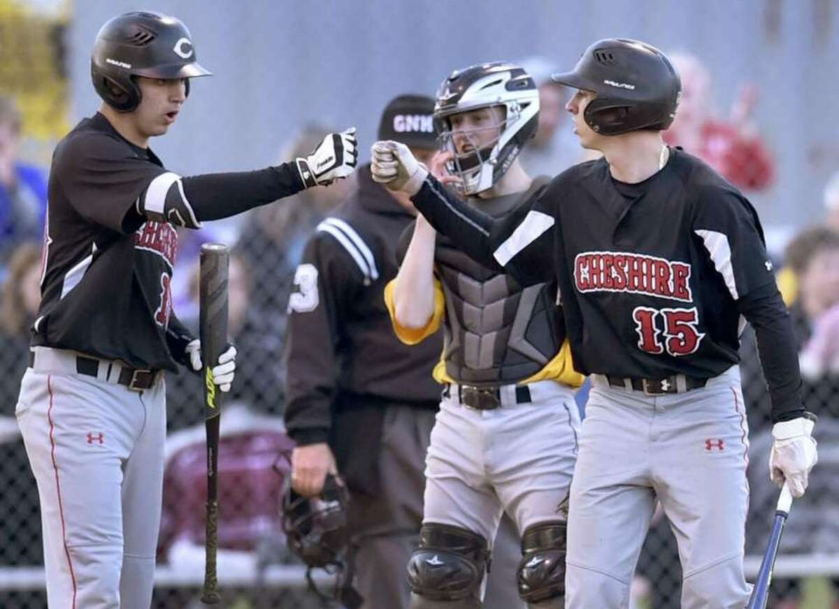 Cheshire’s Matt Downing, left, and teammate Ryan Strollo celebrate a run during the third inning against Amity on Wednesday at the Old Tavern Road Complex in Orange. Photo: Peter Hvizdak / Hearst Connecticut Media