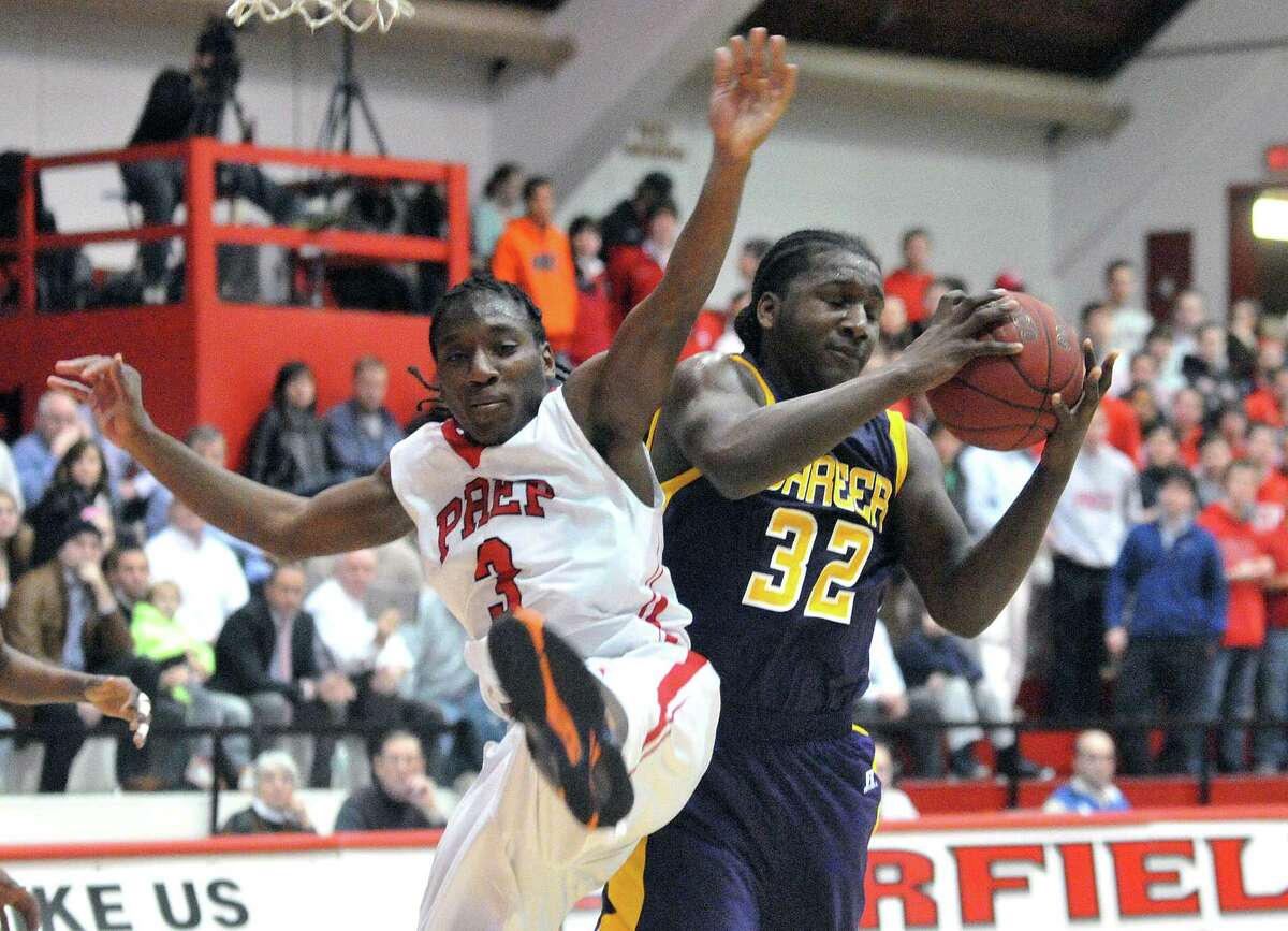 (Peter Casolino-New Haven Register) Career’s Jordan Lomax takes the rebound over Fairfield Prep’s Keith Pettway during the first half of Prep’s 71-65 win. Prep is still No. 1 in the latest poll while Career dropped to No. 6.