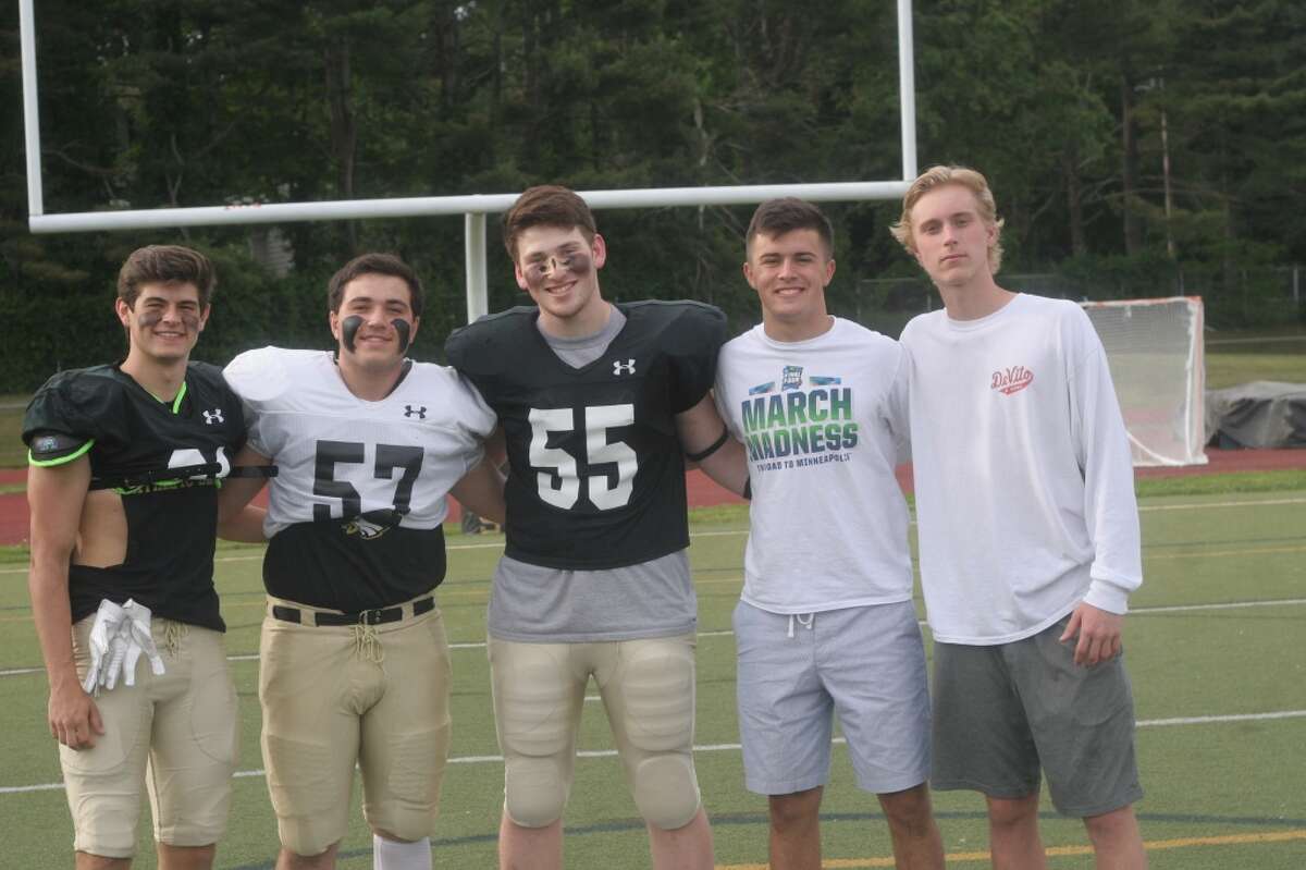 Trumbull High captains’ Cole Smith, Matt Delaney, Coby Levinson, Kyle Atherton and Nolan Shea get together before Friday night’s Black and Gold game.