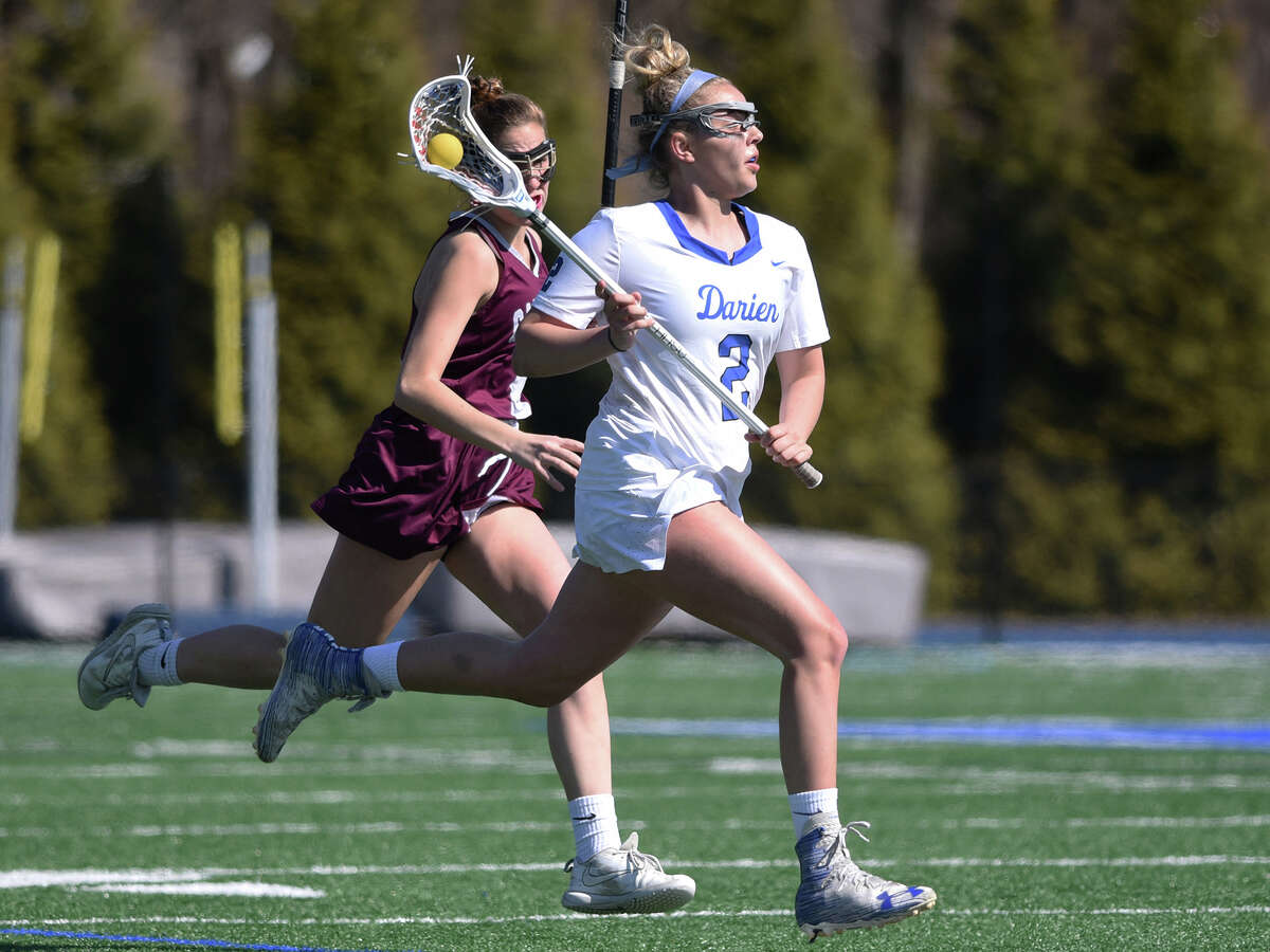 Darien’s Ashley Humphrey (2) beats an opponent through the midfield during a girls lacrosse game against Garden City at Darien High School on Saturday, April 6, 2019.