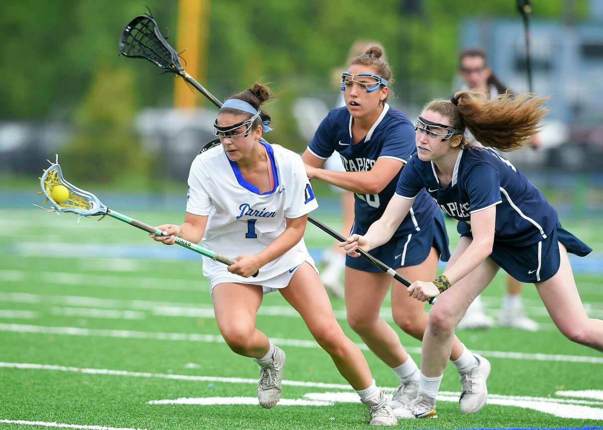 Staples' Kyle Kirby (24) and Christine Taylor (20) defend the drive of Darien's Nicole Humphrey (1) in a FCIAC girls lacrosse quarterfinal game at Darien High School in Darien, Conn. on May 16, 2017. Darien defeated Staples 18-6.