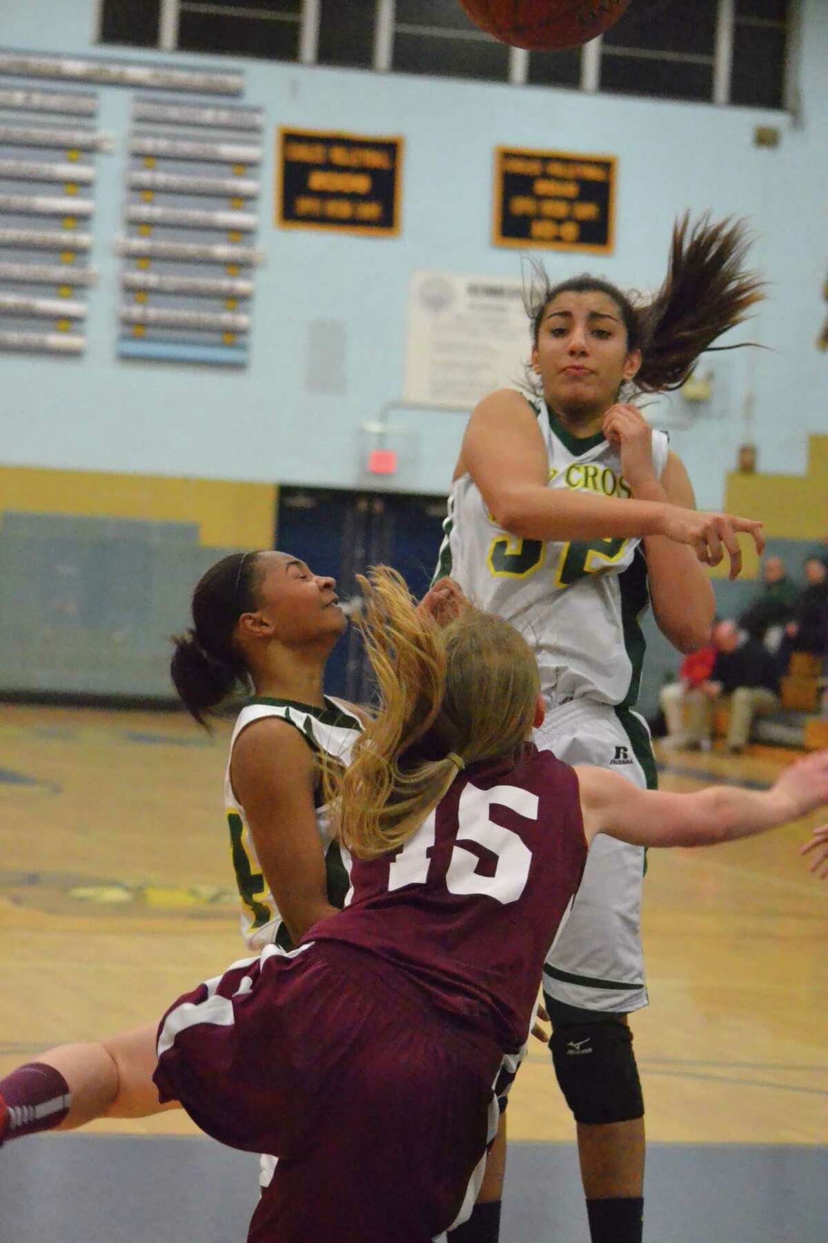 Holy Cross’ Kiera O’Donnell blocks Torrington’s Caroline Teti’s shot attempt in the Crusaders’ 50-41 win over the Red Raiders. With the win Holy Cross clinches a spot in the NVL title game on Friday night.