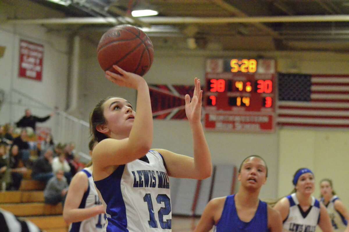 Lewis Mills’ Natalie Ruel lays in two of her 13 points to help lead the Spartans to the BL Tournament finals on Friday night.