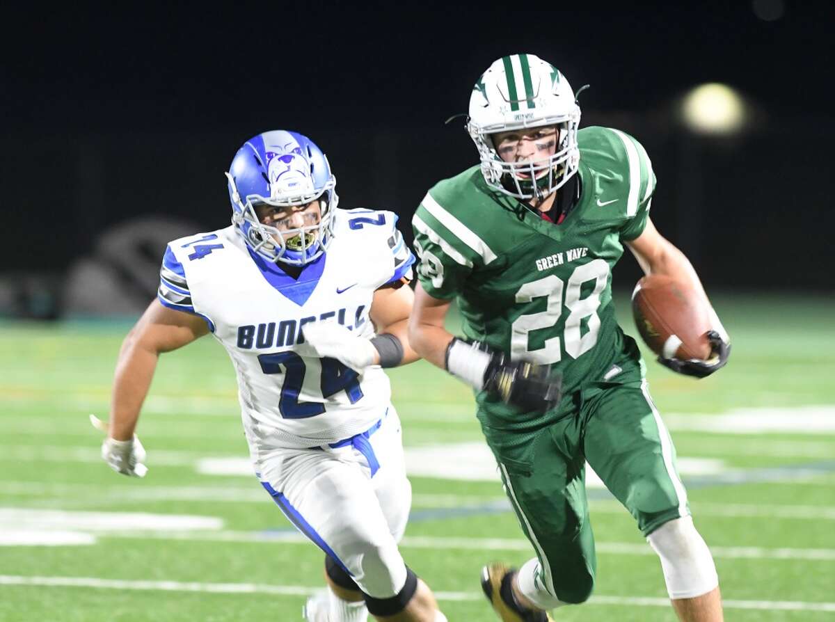 New Milford’s Johnny Fitzmaurice (28) right, is pursued by Bunnell’s Nick Ochoa during the Bunnell at New Milford High School football game, Sept. 21, 2018. (Photo Krista Benson / For Hearst Connecticut Media).