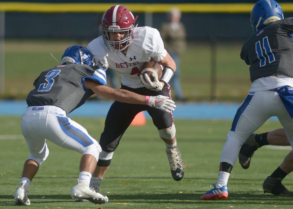 Bethel’s Michael Reseska tries to elude a tackle during a game vs. Bunnell last season (Erik Trautmann, Hearst Connecticut Media)