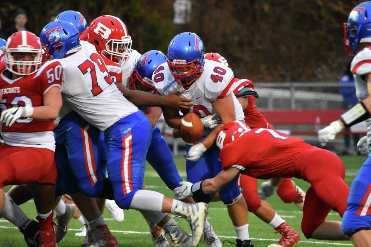 Berlin’s Daniel Lynch forces a fumble vs. Tolland at Berlin high school on Thursday, Sept. 12, 2019. (Pete Paguaga, Hearst Connecticut Media)