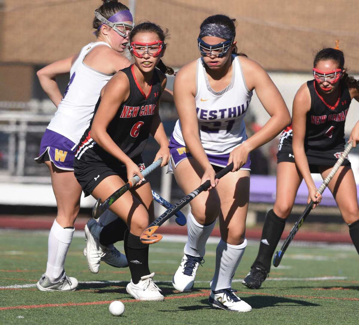Westhill's Olivia Conte (27) and New Canaan's Ellie Luciano (6) battle for the ball during a field hockey game at Westhill High School in Stamford on Thursday, Sept. 19, 2019.