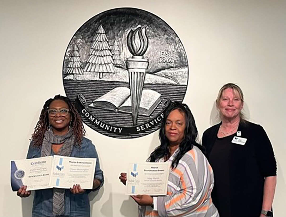 Baldwin Community Schools board trustee Shawn Ware (left) and board president Mary Martin (right) are pictured with Jill Fennessy, president of the Michigan Association of School Boards.