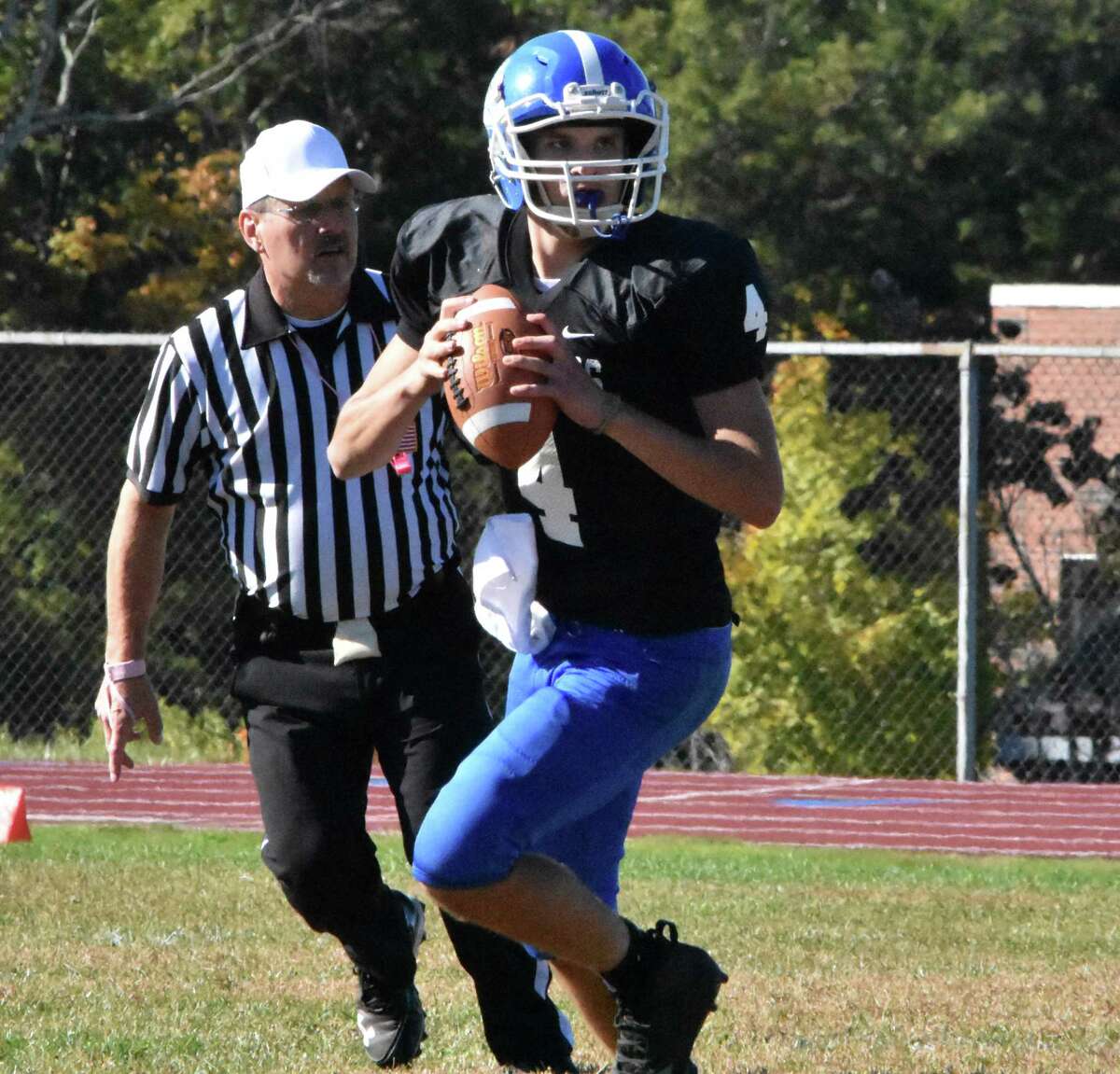 Stafford/East Windsor/Somers quarterback Tyler Ouellette rolls out against Valley Regional at Stafford high school on Saturday, Oct. 5, 2019. (Pete Paguaga, Hearst Connecticut Media)