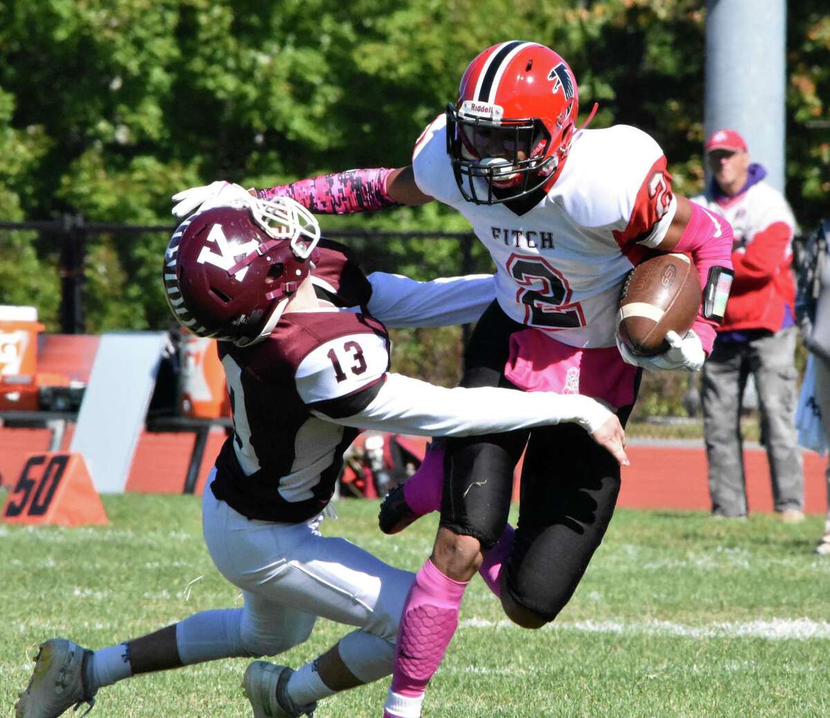 Fitch’s Lashier Edwards stiff arms Killingly’s Cooper Morissette at Killingly high school on Saturday, Oct. 5, 2019. (Pete Paguaga, Hearst Connecticut Media)