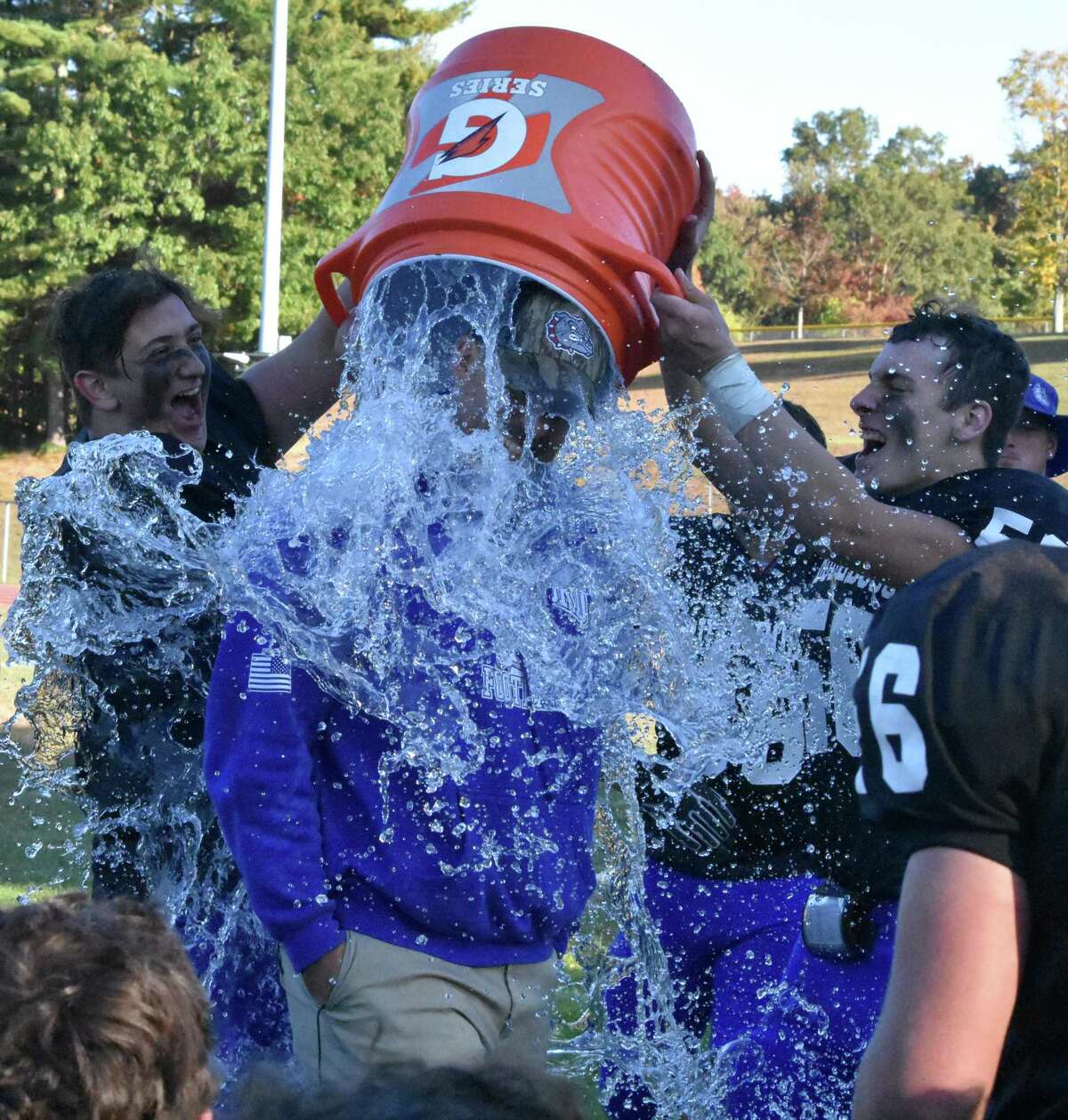 Stafford/East Windsor/Somers coach Brian Mazzone is given a Gatorade bath by his team after they beat Valley Regional/Old Lyme 21-7 at Stafford high school on Saturday, Oct. 5, 2019. (Pete Paguaga, Hearst Connecticut Media)