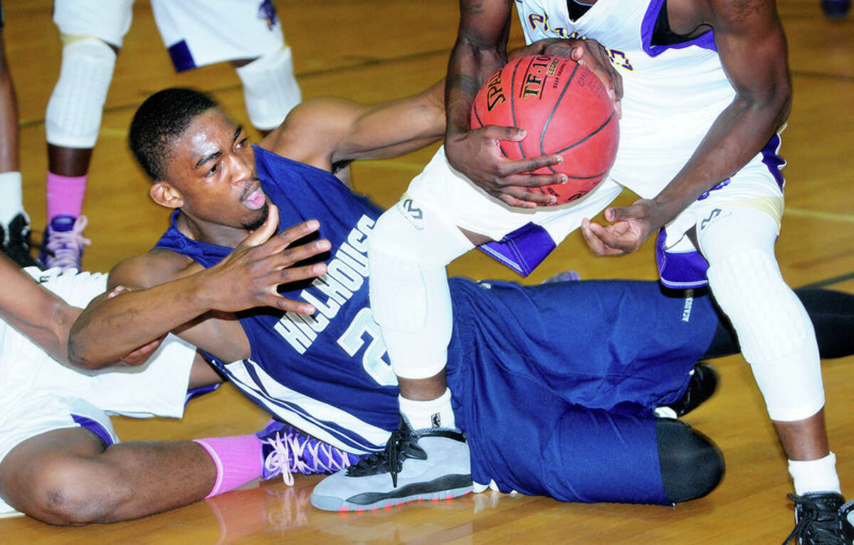 Raiquan Clark (center) of Hillhouse fights for the ball against Career in the first half of the SCC Boys Basketball Semifinal in East Haven on 3/3/2014. Photo by Arnold Gold / Register