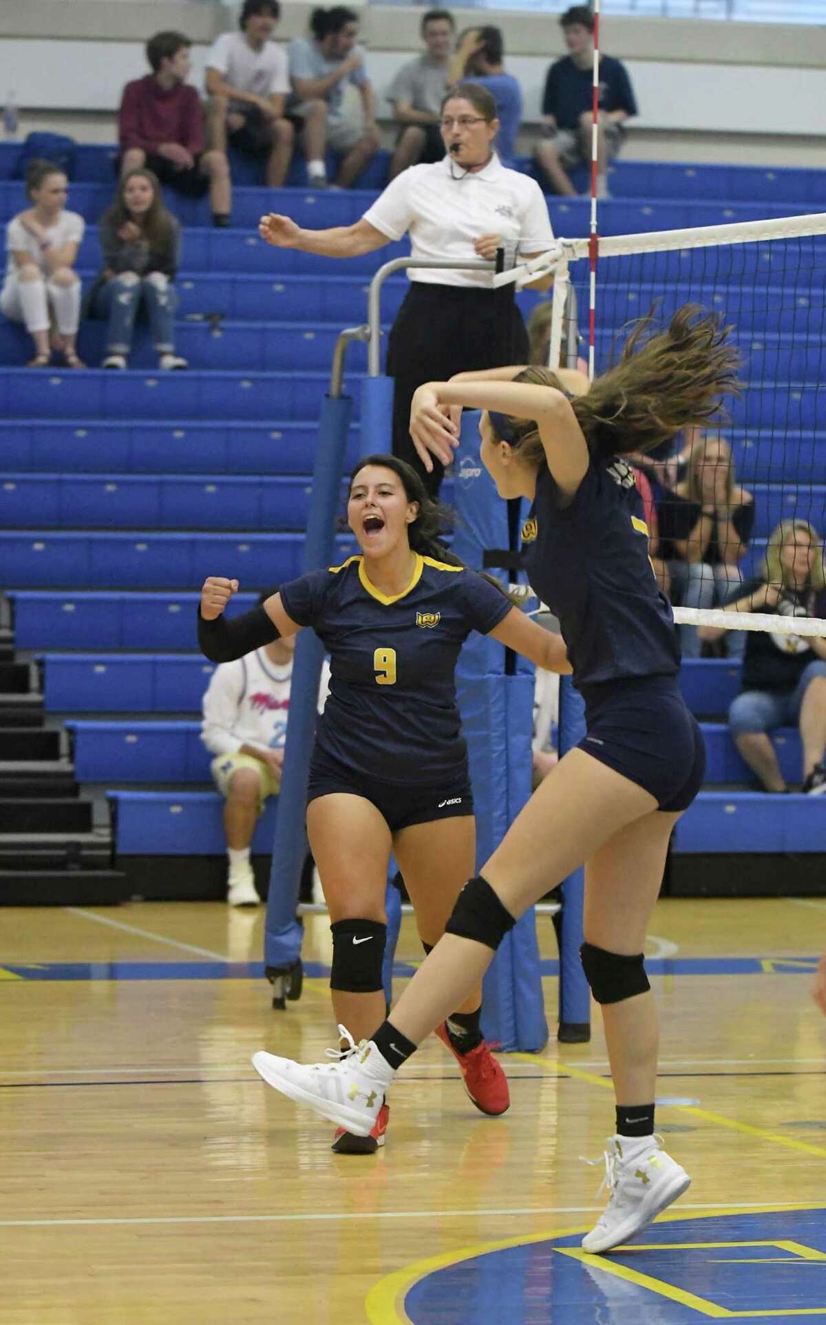 Woodstock Academy’s Paula Hernandez, left, and Marissa Mayhew celebrate during the Woodstock Academy at Newtown High School girls volleyball game, Sept. 17, 2018.