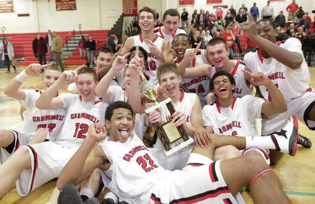 The Cromwell Boys Basketball team celebrate their victory claiming the 2014 Shoreline League Basketball championship against East Hampton at Wilbur Cross High School (John Vanacore for the Register)