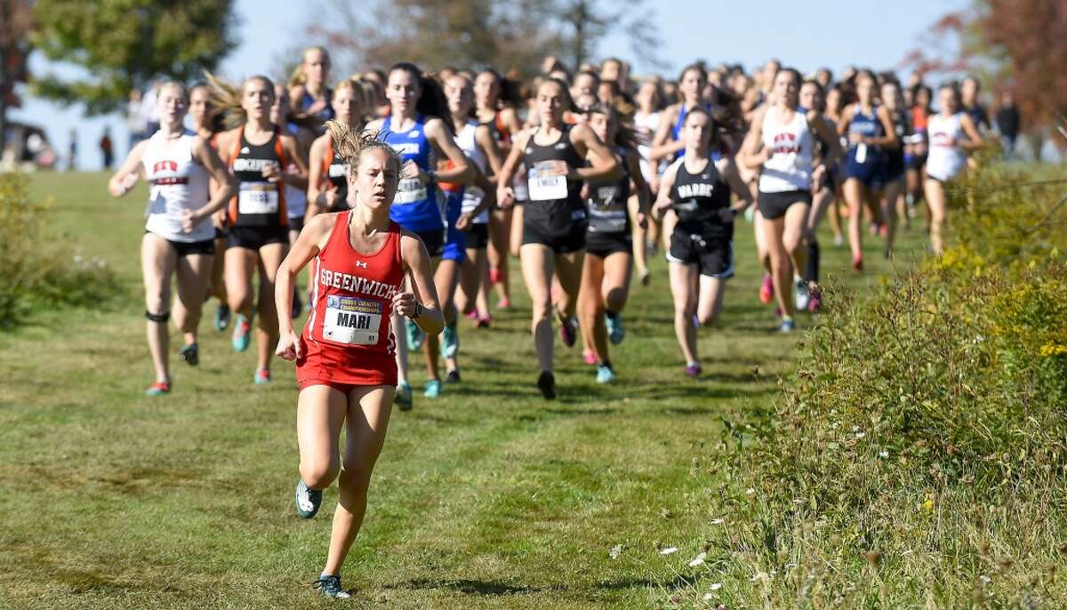 Greenwich’s Mari Noble leads competitors in the Varsity Girls 4000 meter run of the FCIAC cross country championships at Waveny Park in New Canaan, Conn. on Oct. 15, 2019. Noble went on to win the race, placing first with a personal best time of 14:05.00.
