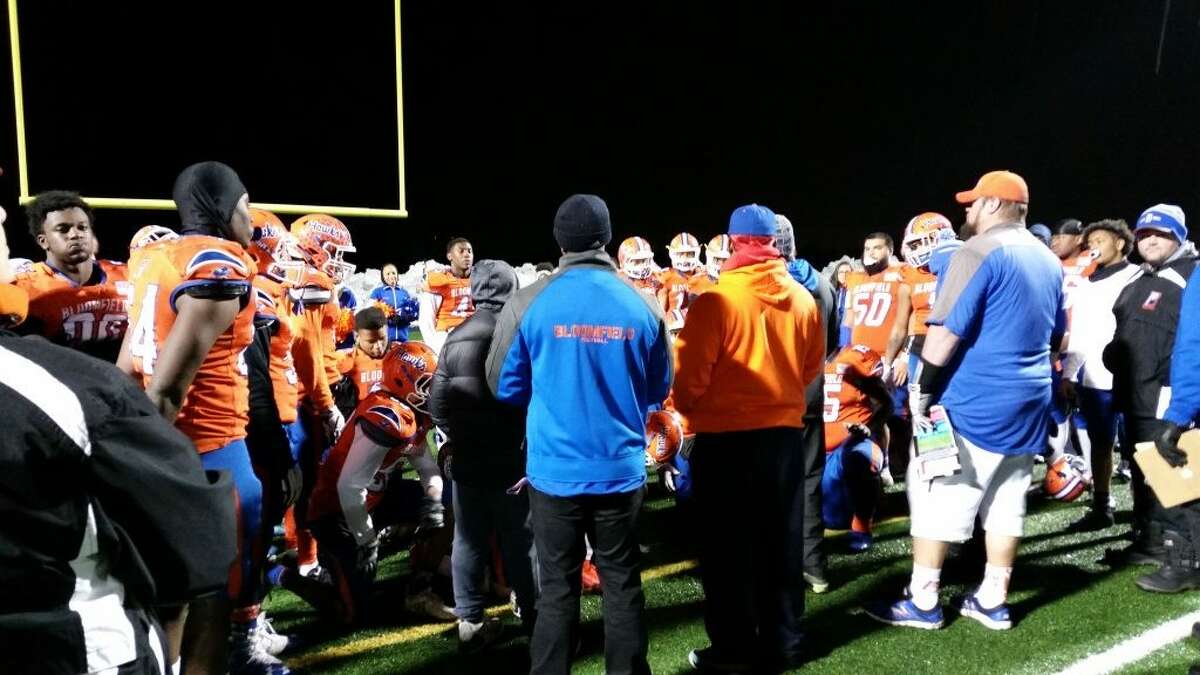 Bloomfield huddles after its 56-0 win over Stafford/East Windsor/Somers on Wednesday, Dec. 4, 2019, at Phil Rubin Stadium in the Class S football quarterfinals. / Michael Fornabaio – Hearst Connecticut Media
