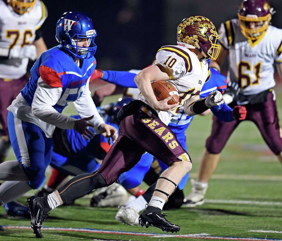 12/4/19 :: SPORTS :: DIMAURO :: Granby/Canton's Jackson Rome (10) races for yardage with Waterford's Thomas Pitasi (58) in pursuit in CIAC Class M football quarterfinal action Wednesday, December 4, 2019.