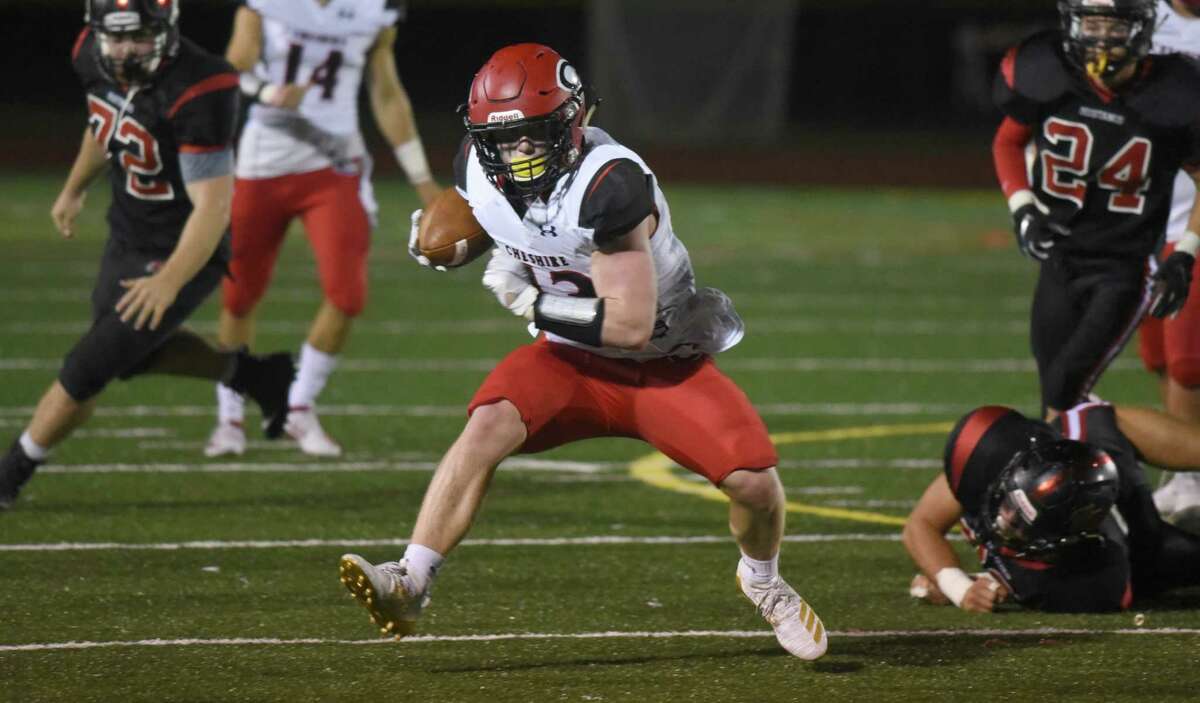 Cheshire’s Jake McAlinden runs for some of his 197 yards during a football game between Cheshire and Warde in Fairfield on Friday, Sept. 27, 2019.