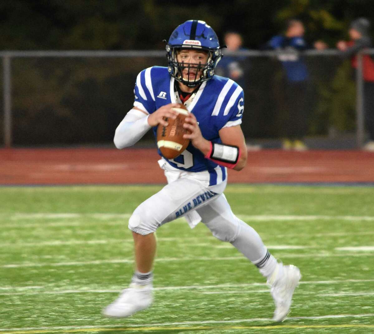 Plainville quarterback Christian Collin rolls out vs. Bloomfield at Plainville high school on Oct. 4, 2019. (Pete Paguaga, Hearst Connecticut Media)