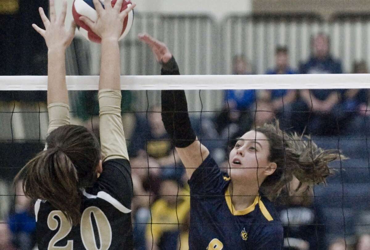 Woodstock Academy’s Paula Hernandez tips the ball over the net in the class L volleyball championship game against Joel Barlow High School, played at East Haven High School. Nov. 17, 2018. 