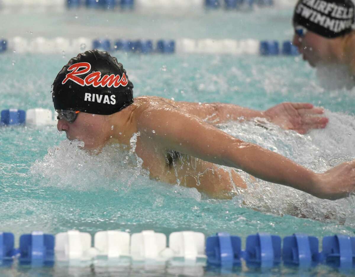 New Canaan's Michael Rivas competes in the 100 butterfly during a swimming and diving meet between New Canaan and Ludlowe at the New Canaan YMCA on Friday, Jan. 31, 2020.