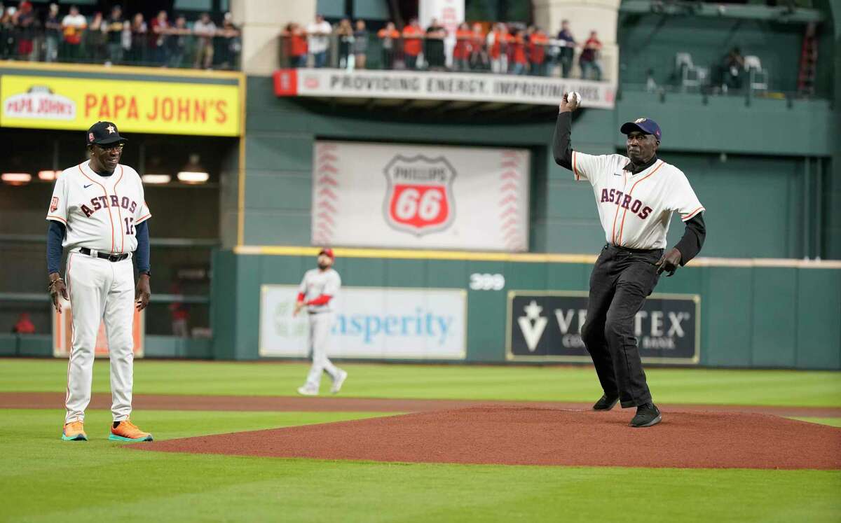 J. C. Hartman throws out the first pitch with Houston Astros manager Dusty Baker Jr. before the start of an MLB baseball game at Minute Maid Park on Tuesday, April 19, 2022 in Houston.