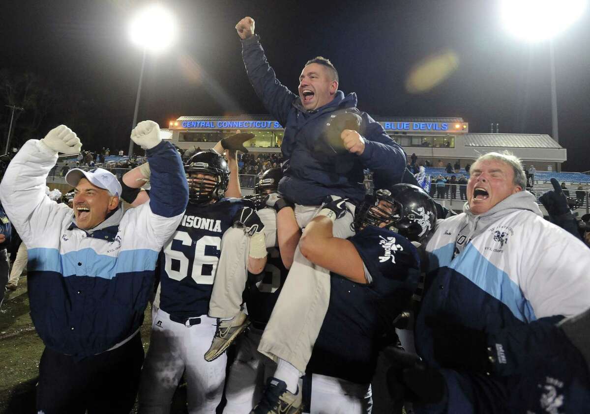 Ansonia coach Tom Brockett gets a ride from his team after the Chargers won the Class S Championship, 51-12 over Woodland at Arute Field in Central Connecticut.  Brockett is the Doc McInerney Men's High School Coach of the Year by the Connecticut Sportswriters Alliance.  (Photo Mara Lavitt)