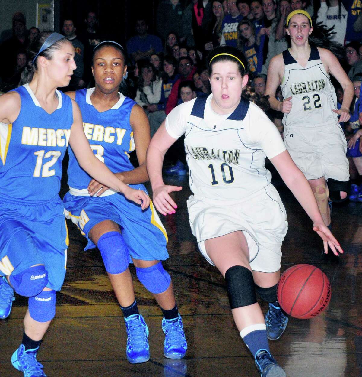 Carly Fabbri (right) of Lauralton Hall moves the ball up the court in the final minutes of the CIAC Class LL semi-final game against Mercy in Wallingford on 3/14/2014. (Arnold Gold-New Haven Register)