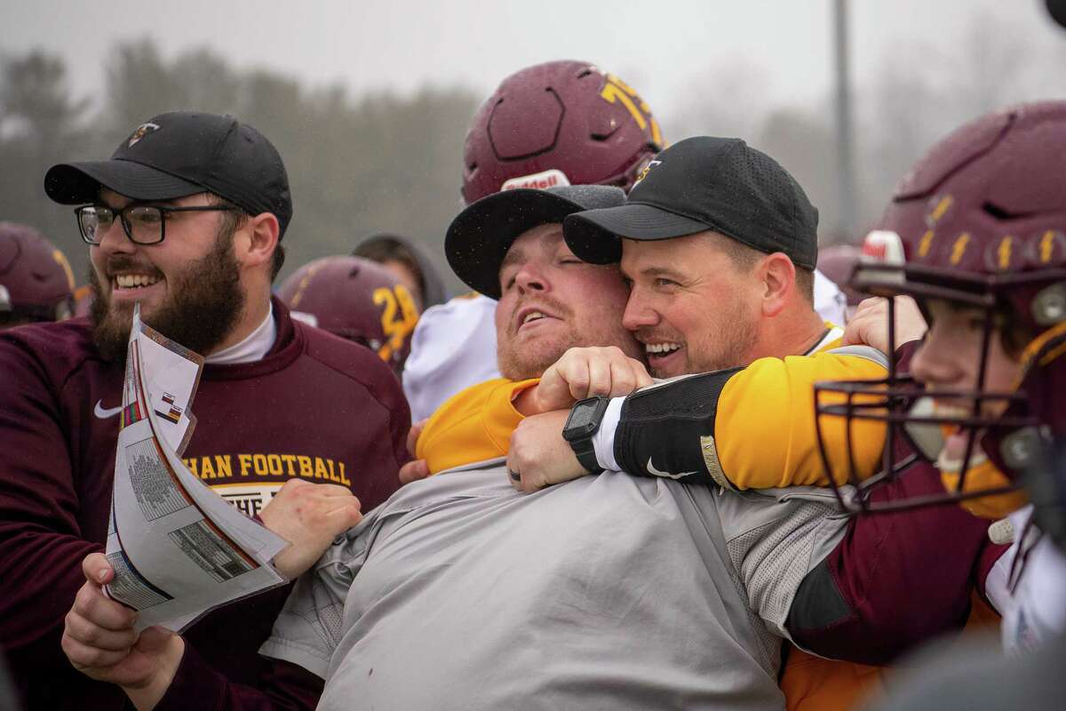 Pat Miller is hugged by head coach John Ferrazzi after Sheehan won the 2019 CIAC Class S football championship in December. Miller was named the new head coach of Norwalk football in January.