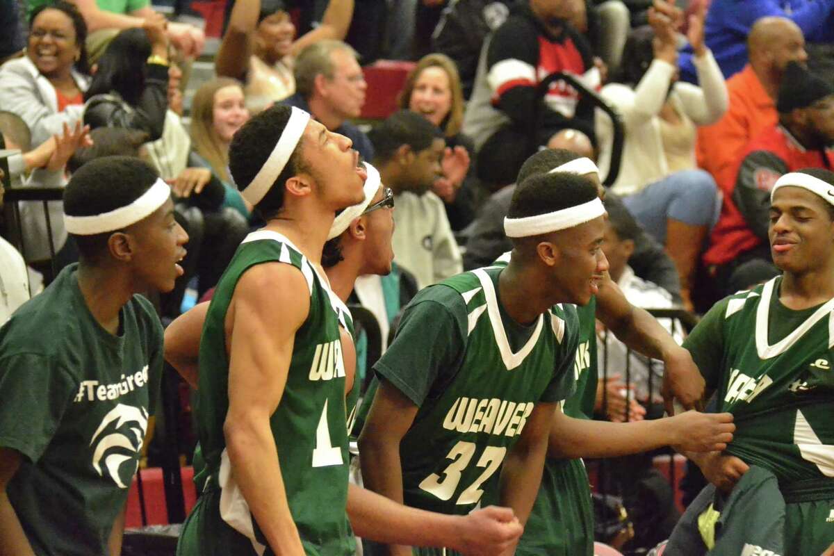 Weaver’s sideline celebrates after one of the seven first quarter three-pointers for the Beavers.