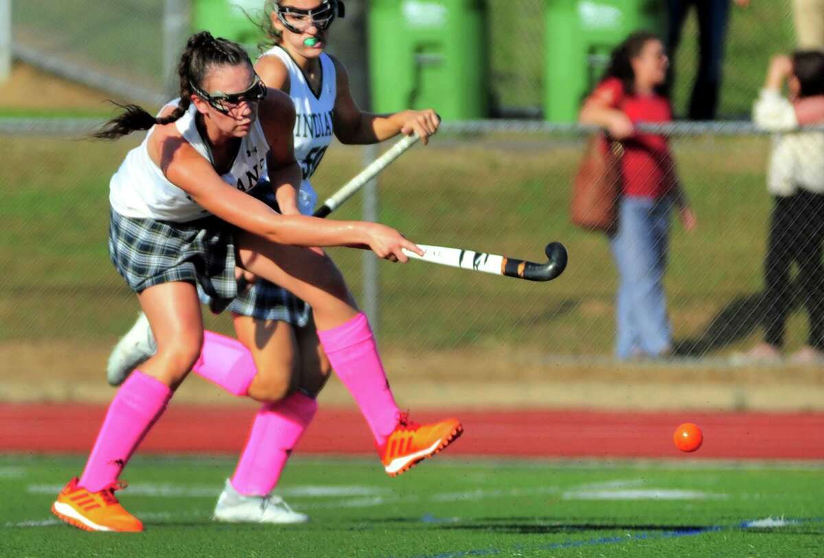 Guilford's Hannah Tillier hits the ball to score a goal against Daniel Hand during field hockey action in Guilford, Conn., on Tuesday Oct. 1, 2019.