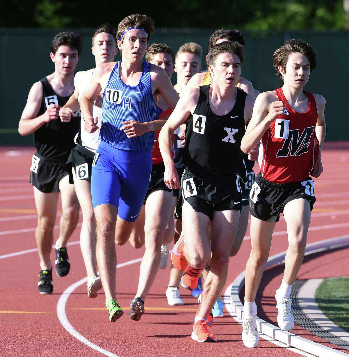 Robbie Cozean (second from right) of Xavier stays on the heels of Aidan Puffer (right) of Manchester in the 3200 meter run at the CIAC State Open Outdoor Track & Field Championship in New Britain on June 3, 2019. Cozean won the event and Puffer placed second.